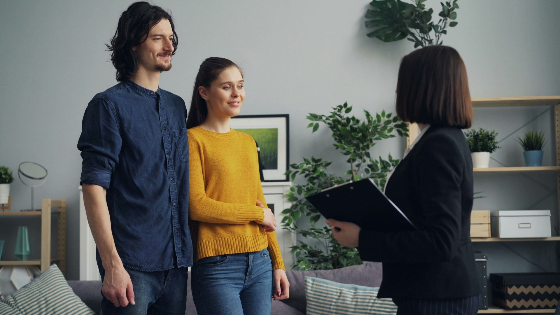 a man and a woman standing in a living room