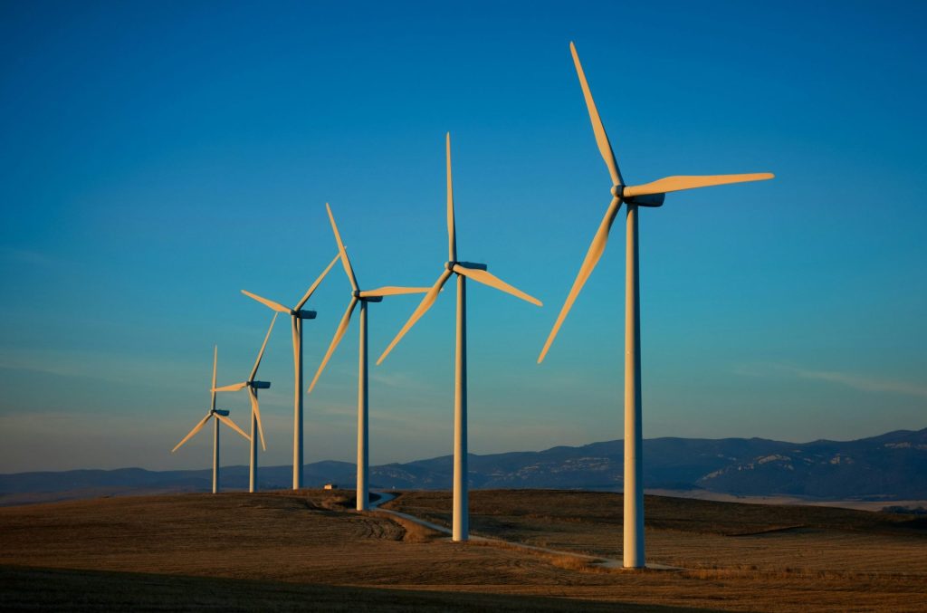 a row of wind turbines in a field